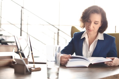 Female lawyer working at table in office