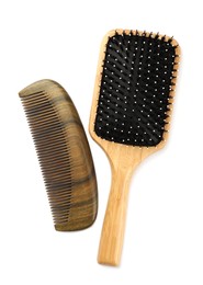 Photo of New wooden hair brush and comb isolated on white, top view