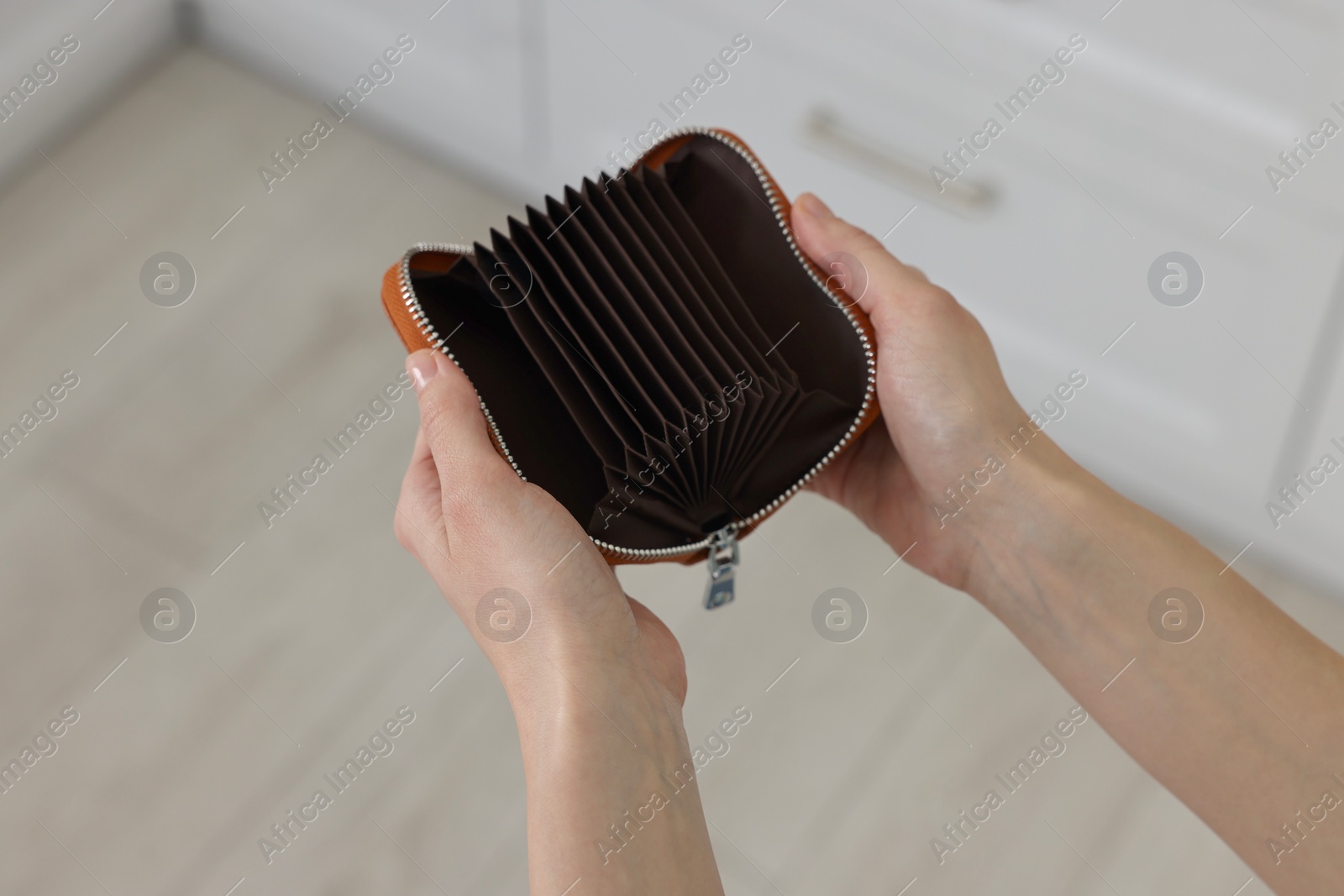 Photo of Woman with empty wallet at home, closeup