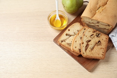 Flat lay composition with pear bread on wooden table, space for text. Homemade cake