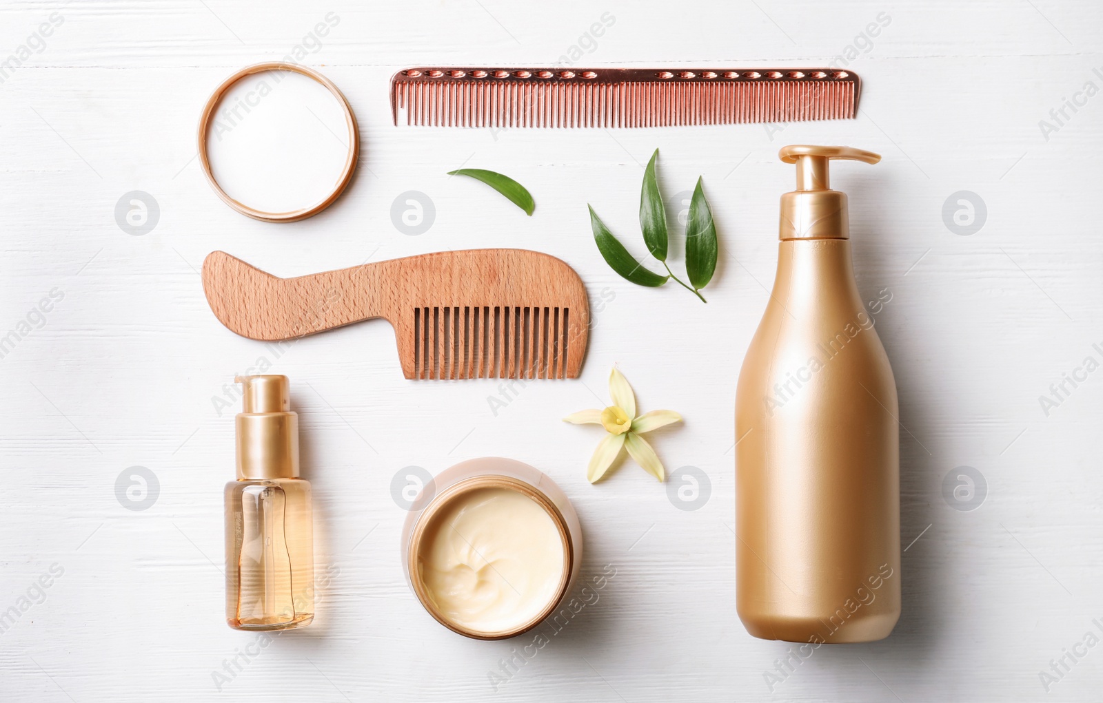 Photo of Flat lay composition with hair cosmetic products on white wooden table