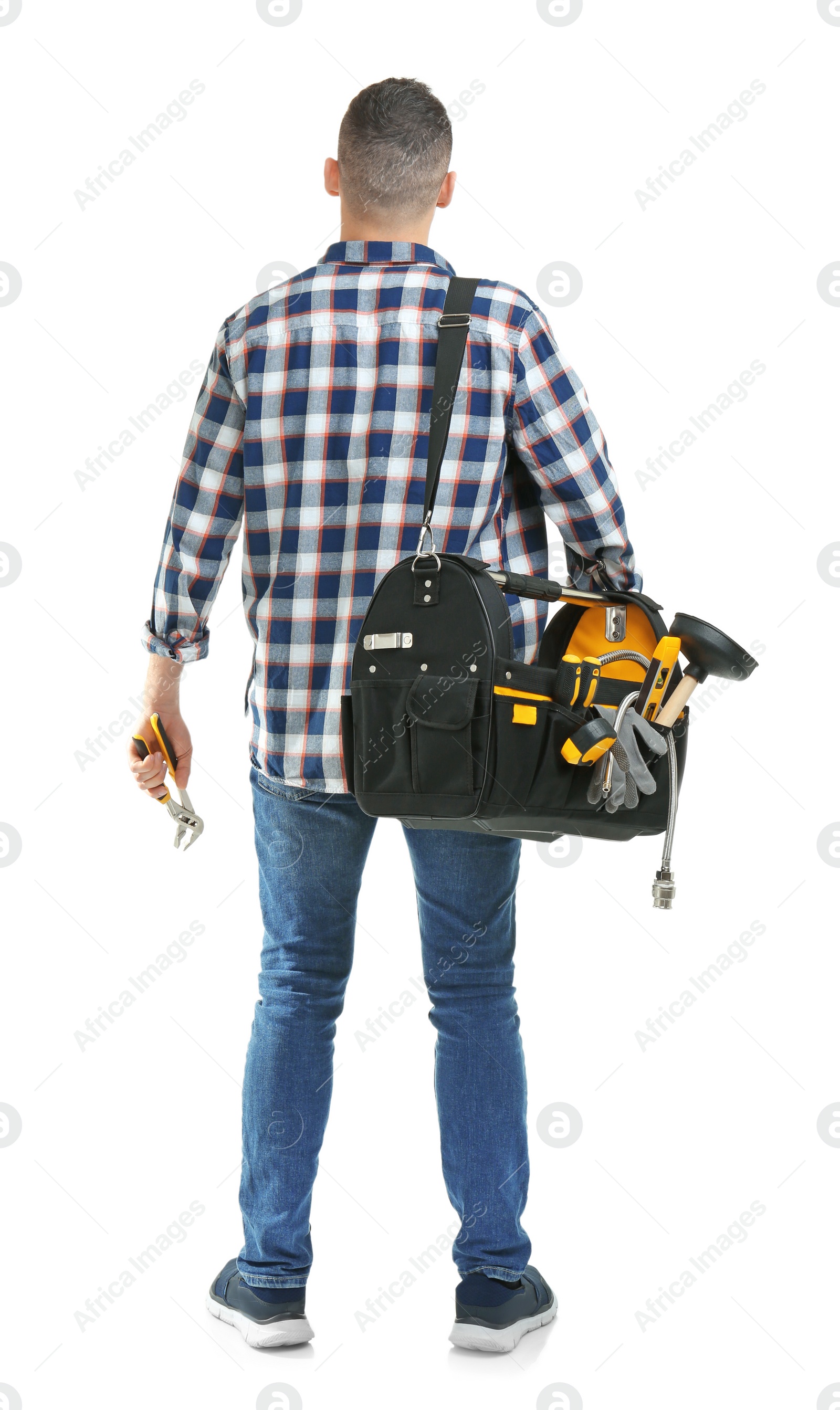 Photo of Young plumber with tool bag on white background