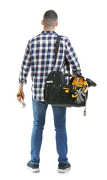 Photo of Young plumber with tool bag on white background