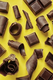 Photo of Yummy chocolate curls on color background, top view