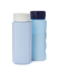 Photo of Bottles of dusting powder on white background, space for design. Baby cosmetic product