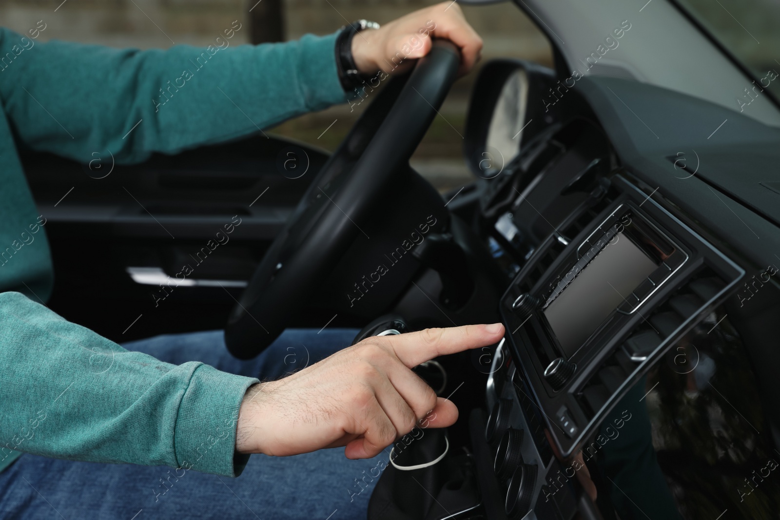 Photo of Driver using modern car navigation system, closeup