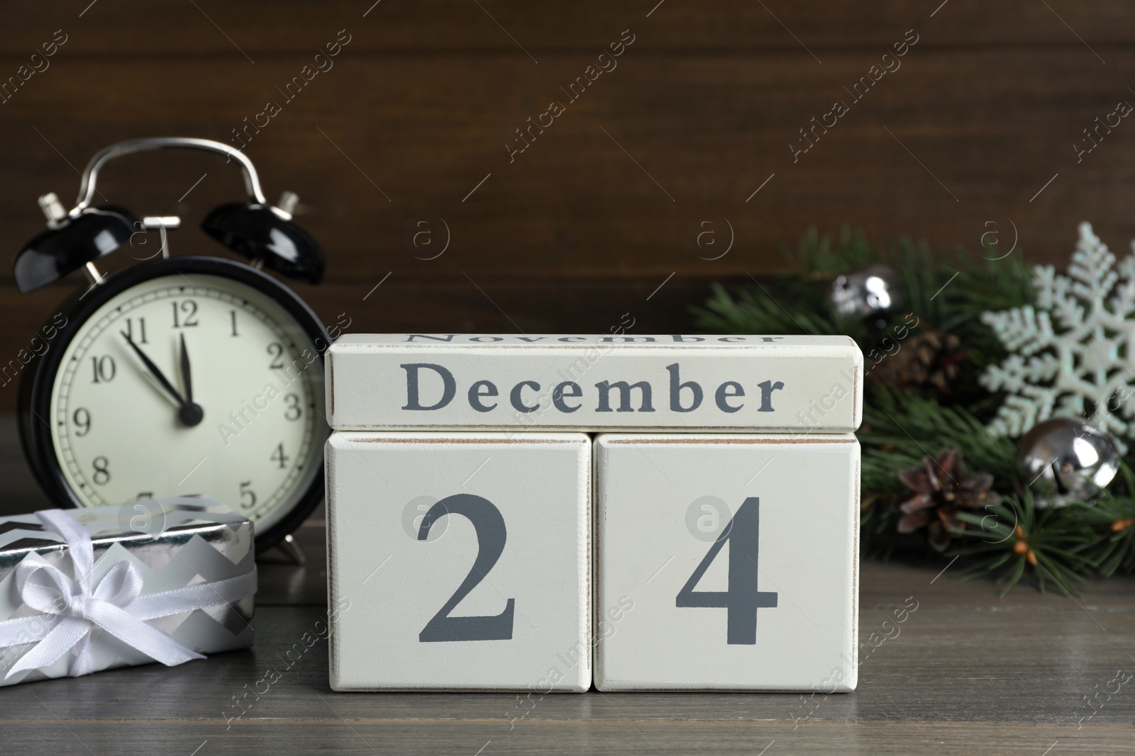Photo of December 24 - Christmas Eve. Wooden block calendar and festive decor on table