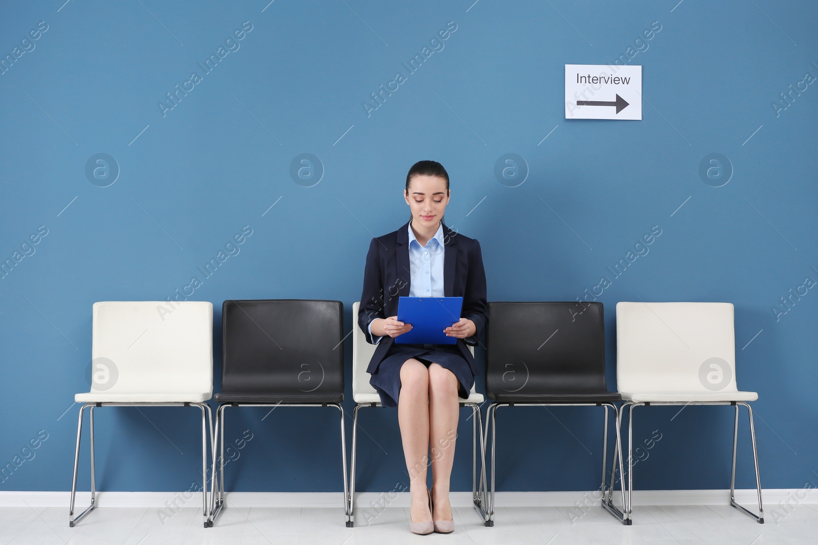 Photo of Young woman waiting for job interview, indoors