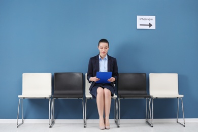 Young woman waiting for job interview, indoors