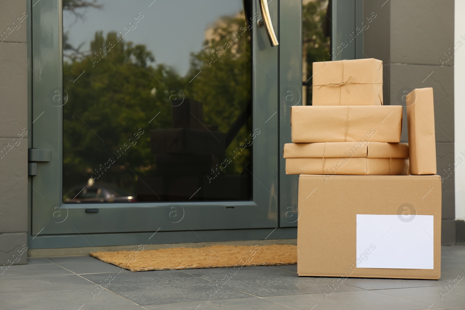 Photo of Cardboard boxes near door. Parcel delivery service