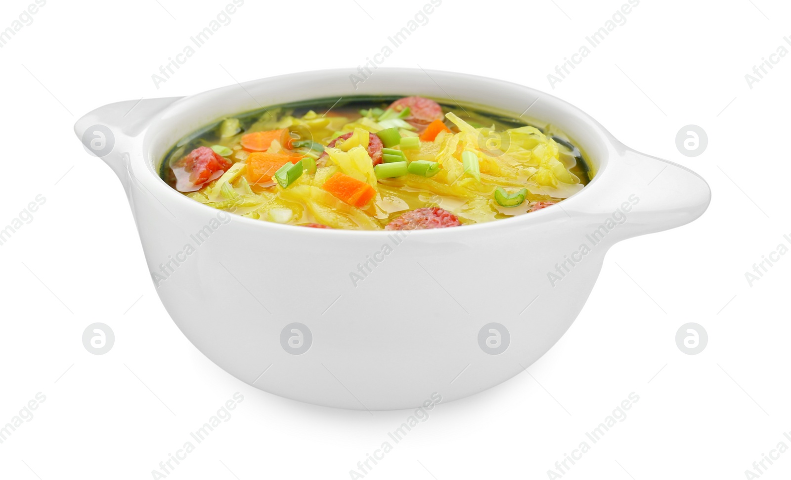 Photo of Bowl of delicious sauerkraut soup with smoked sausages and green onion isolated on white