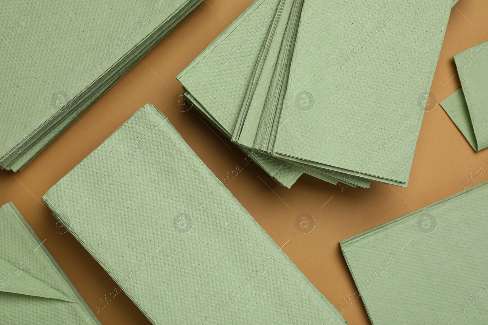 Photo of Paper napkins on brown background, flat lay