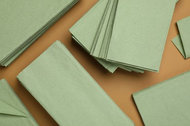 Paper napkins on brown background, flat lay