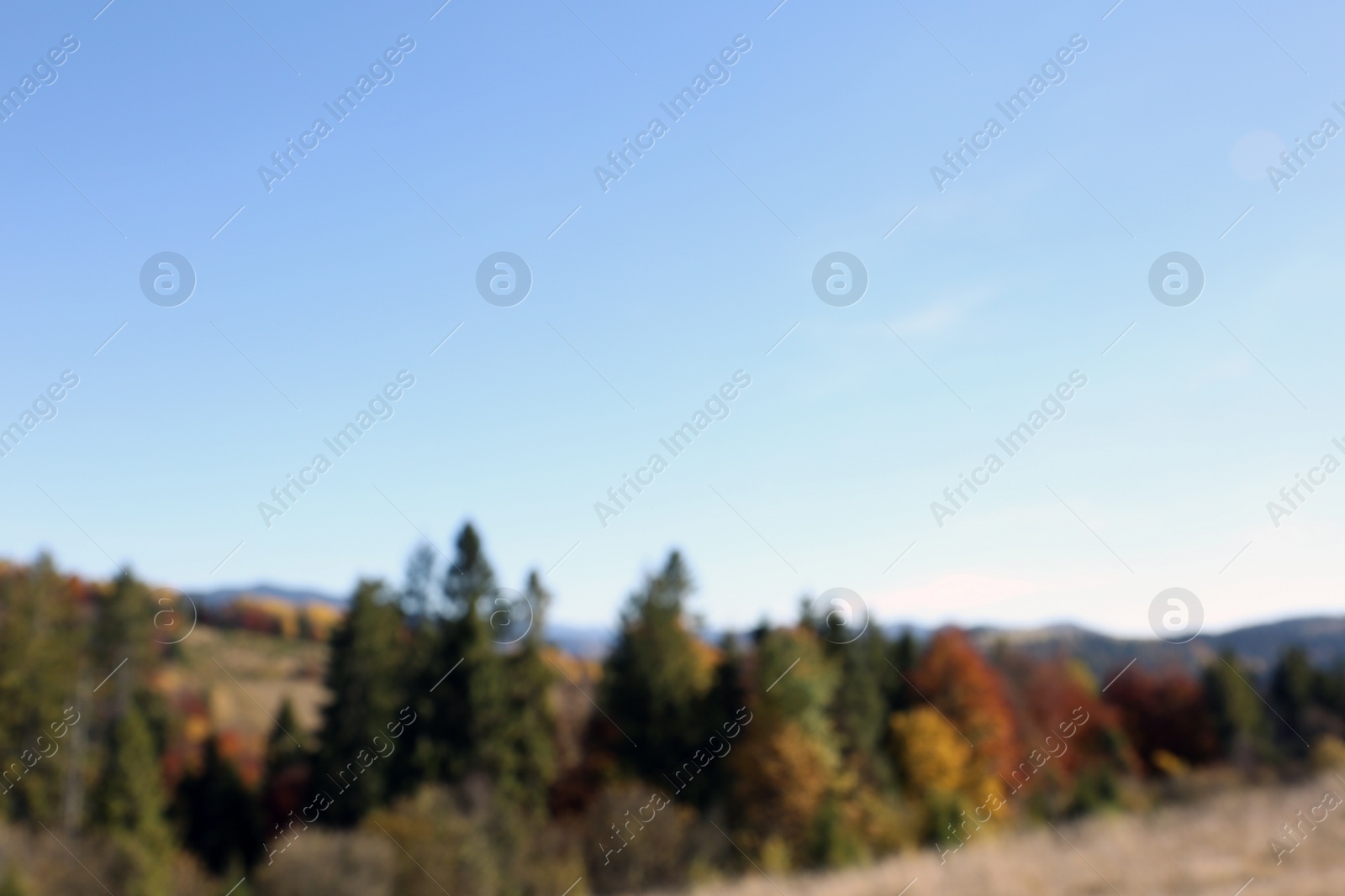 Photo of Picturesque landscape with blue sky over mountains, blurred view