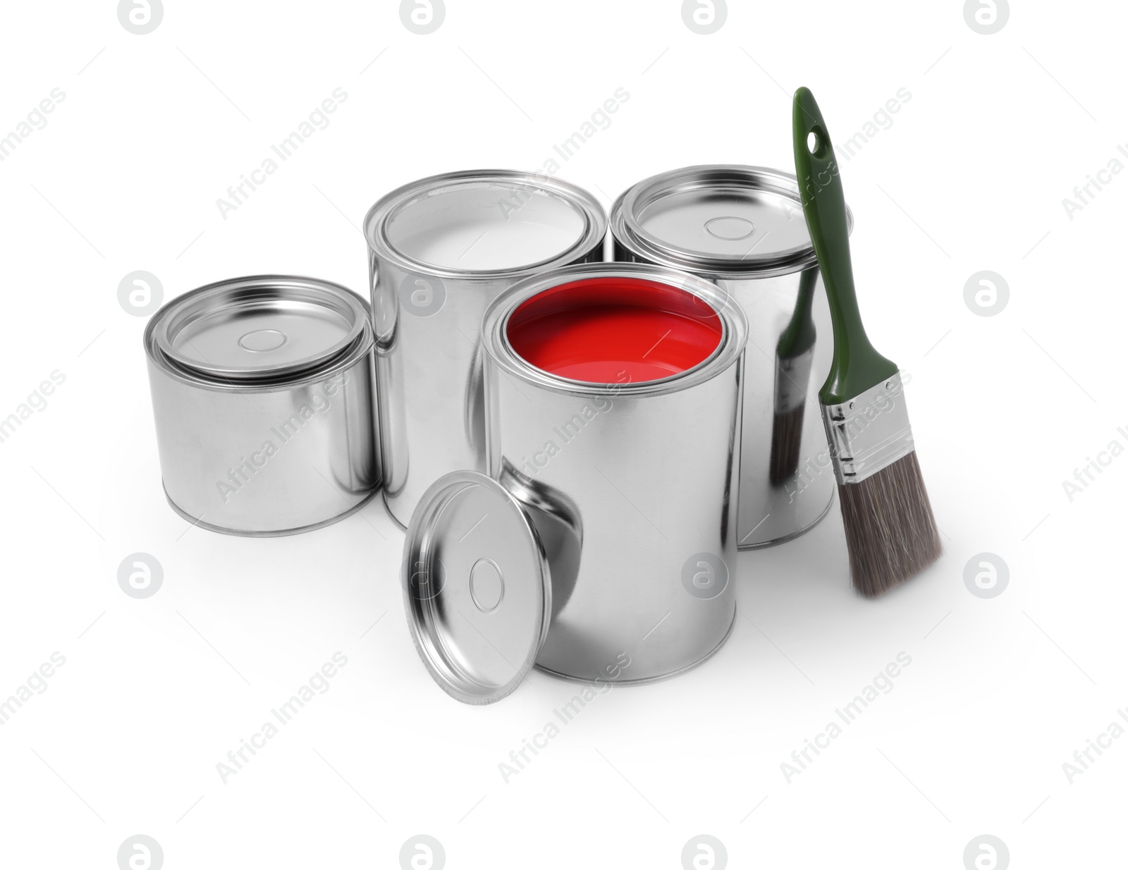 Photo of Cans of color paints and brush on white background