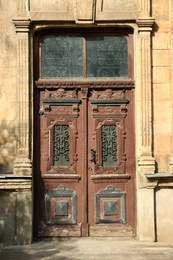 Closed vintage wooden door in old building