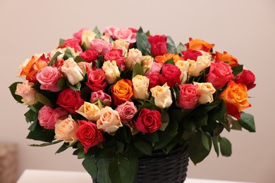 Bouquet of beautiful roses on beige background