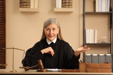 Judge in court dress working at table indoors