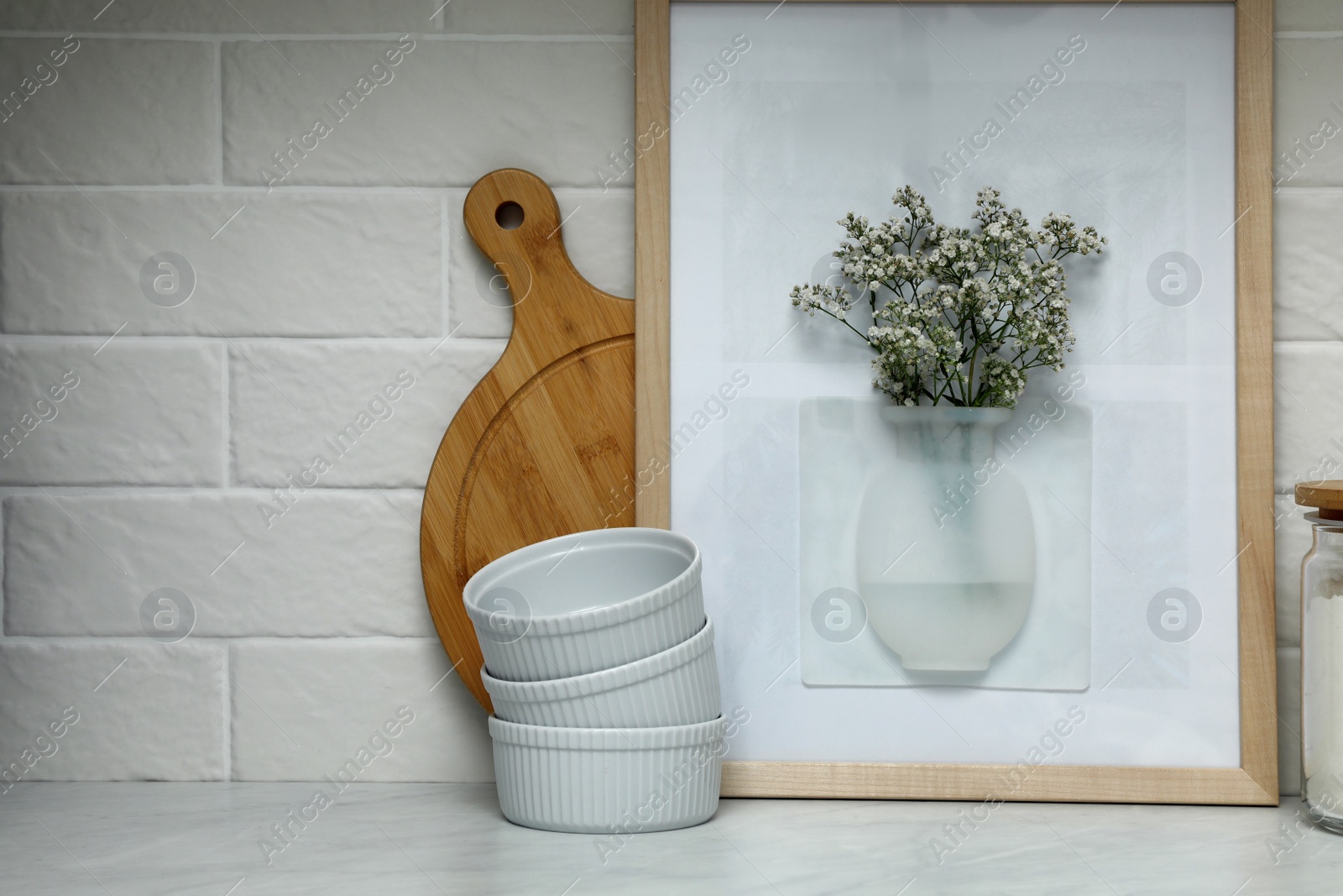 Photo of Silicone vase with flowers on table near wall