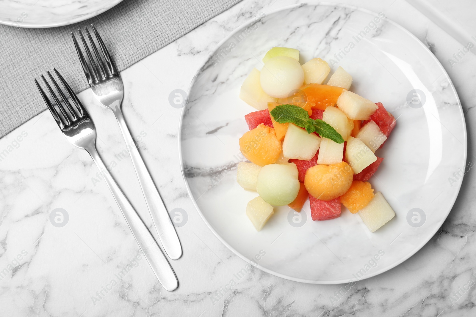 Photo of Salad with watermelon and melon on marble background, flat lay