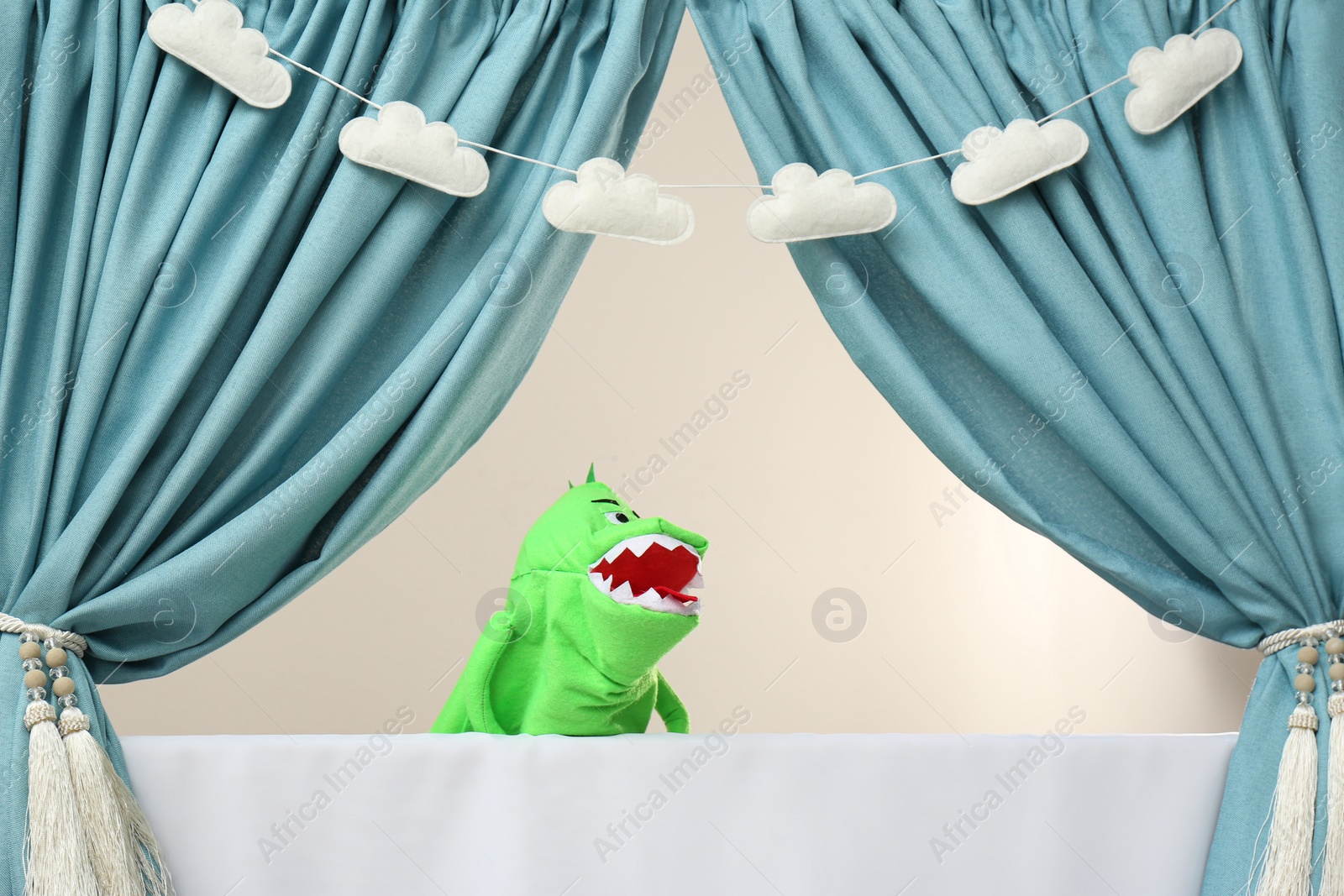 Photo of Creative puppet show on white stage indoors