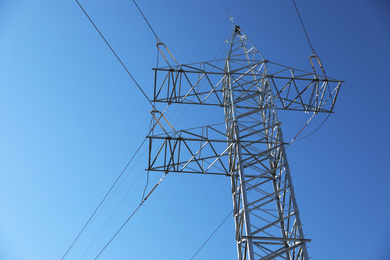 Photo of Modern high voltage tower against blue sky