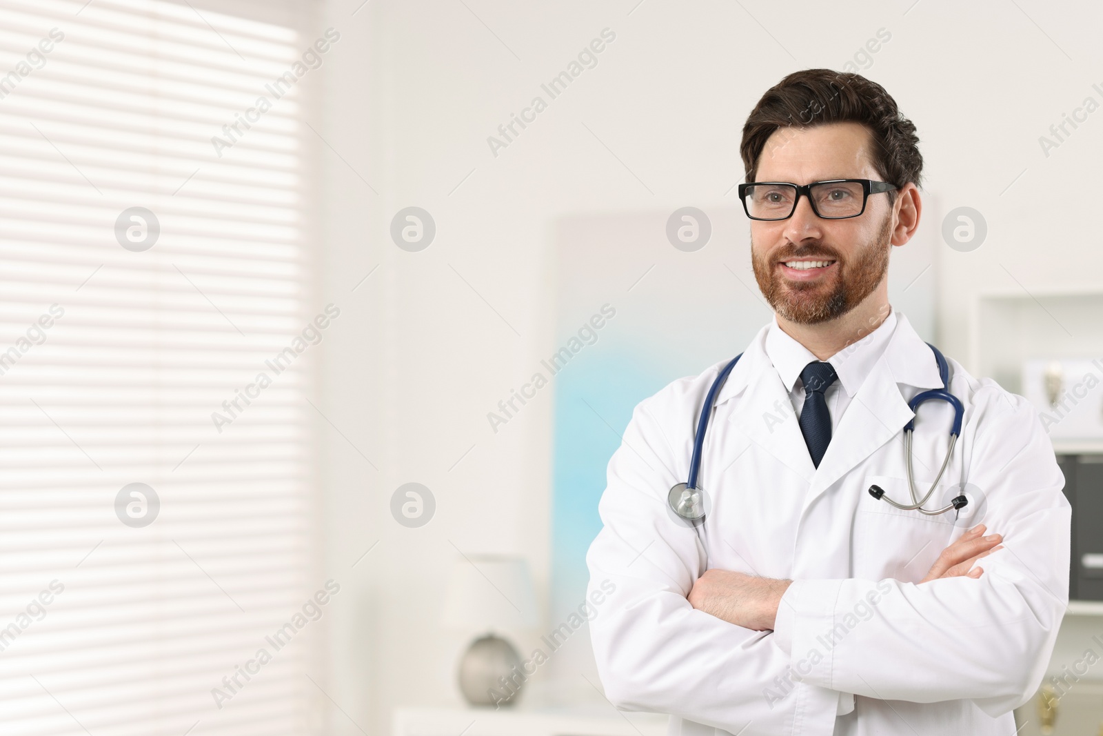 Photo of Medical consultant with glasses and stethoscope in clinic, space for text