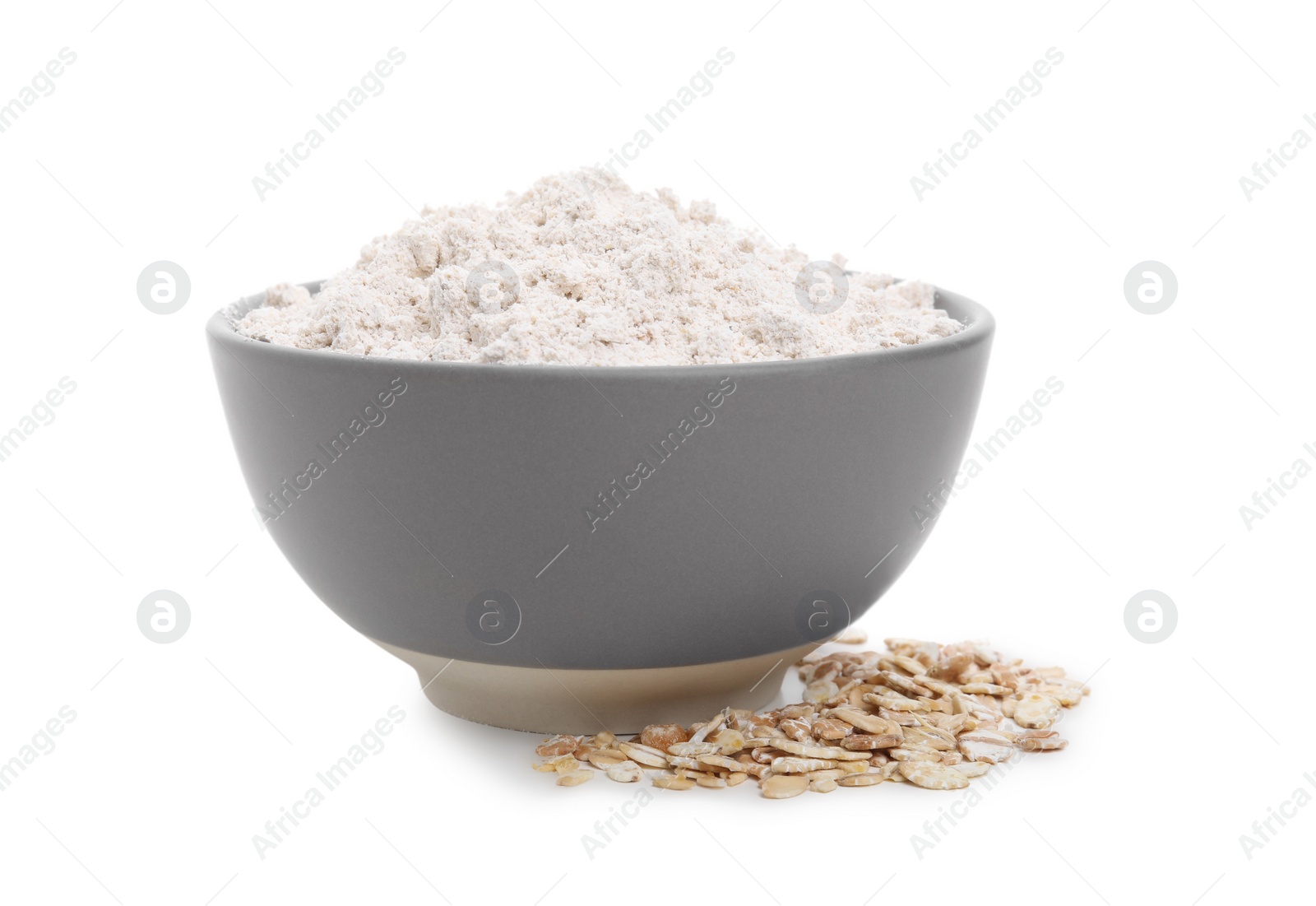 Photo of Bowl with oat flour and flakes on white background