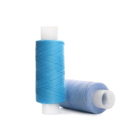 Photo of Different colorful sewing threads on white background