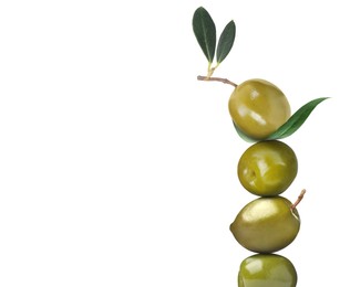 Stack of whole green olives with leaves on white background