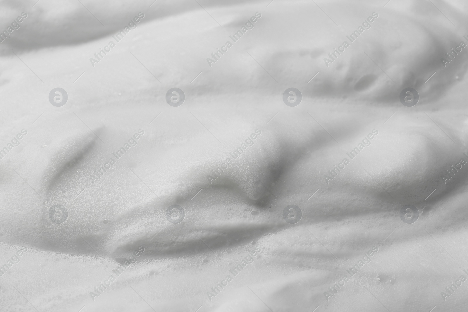 Photo of Foam as background, closeup. Face cleanser, skin care cosmetic