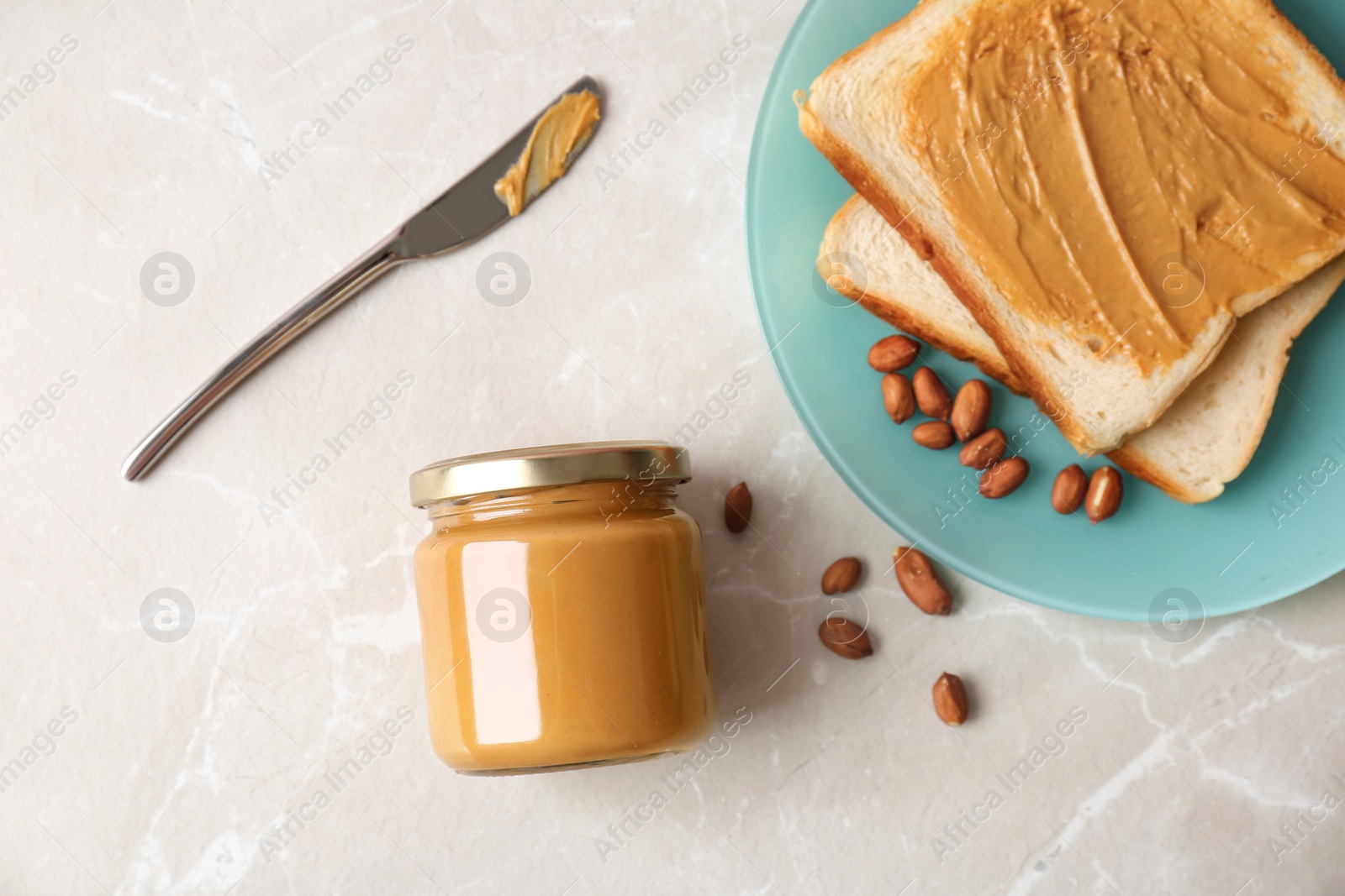 Photo of Flat lay composition with peanut butter and toasts on grey background