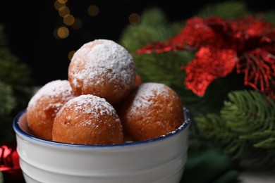 Delicious sweet buns in bowl against blurred background, closeup