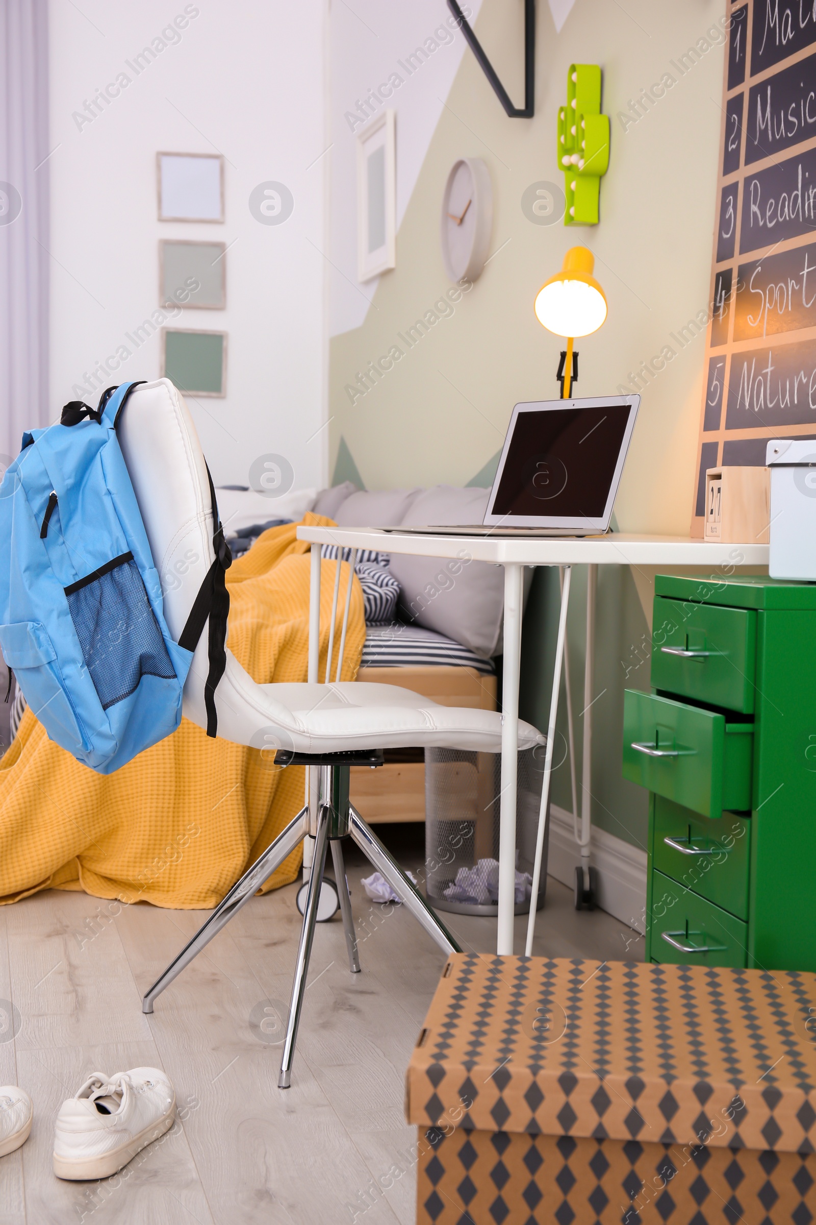 Photo of Modern child room interior with desk and laptop