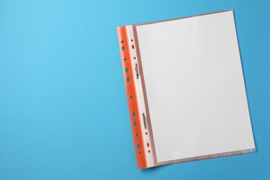 Photo of File folder with punched pockets on light blue background, top view. Space for text