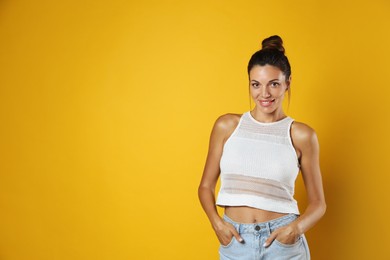 Photo of Portrait of beautiful woman on yellow background, space for text