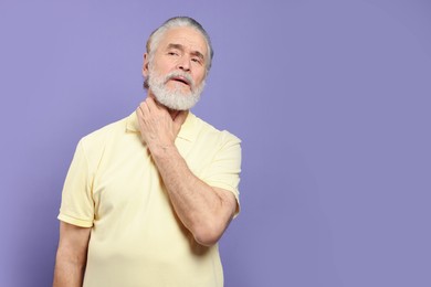 Photo of Senior man suffering from sore throat on light purple background, space for text. Cold symptoms