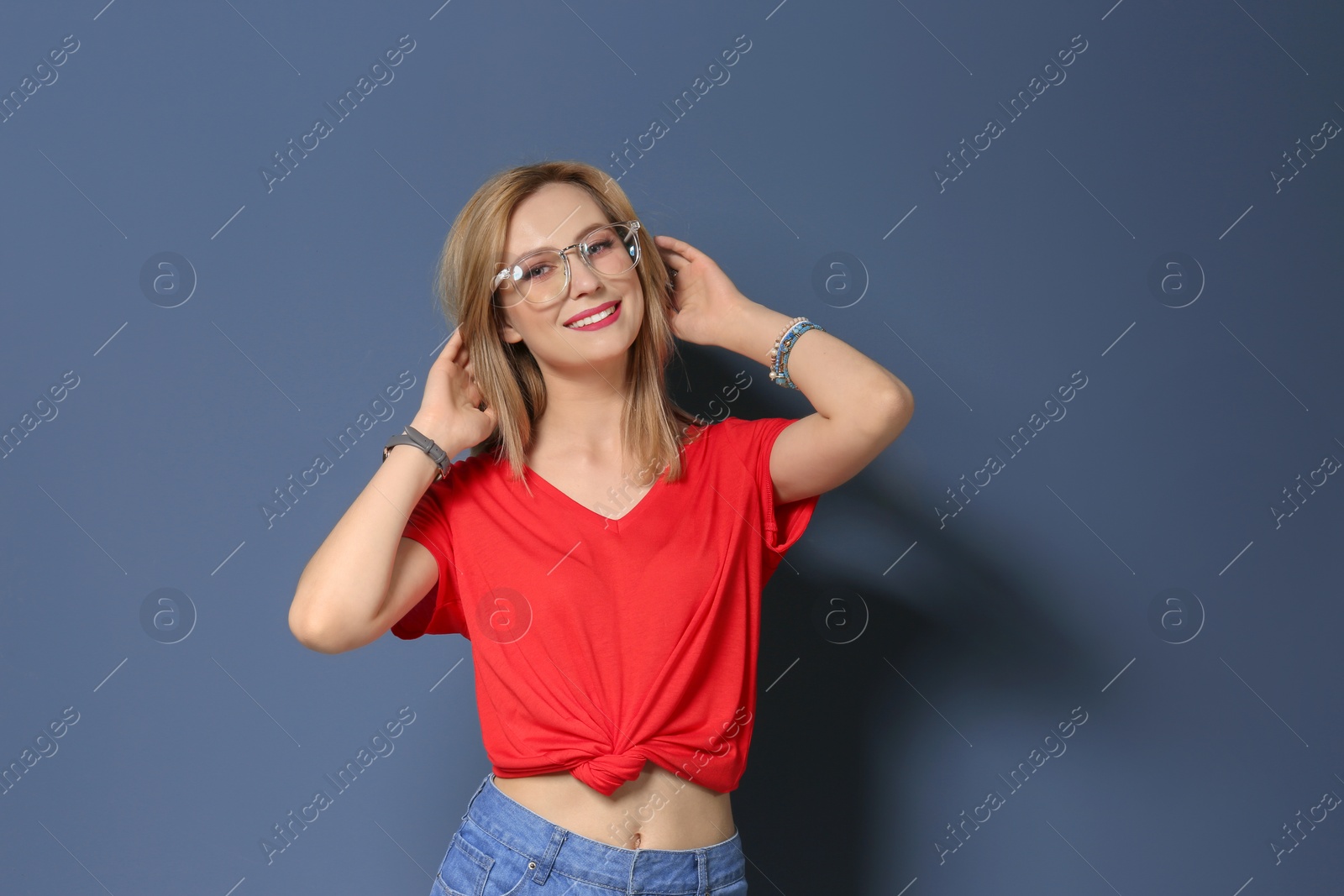 Photo of Attractive young woman in stylish outfit on color background