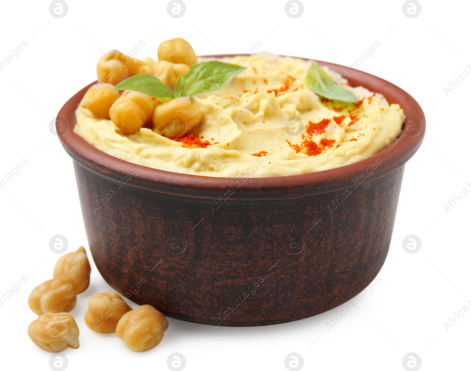 Photo of Bowl of delicious hummus with chickpeas and paprika on white background