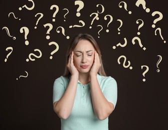 Amnesia. Confused young woman and question marks on brown background