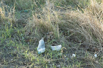 Photo of Used plastic bottle outdoors. Environmental pollution concept