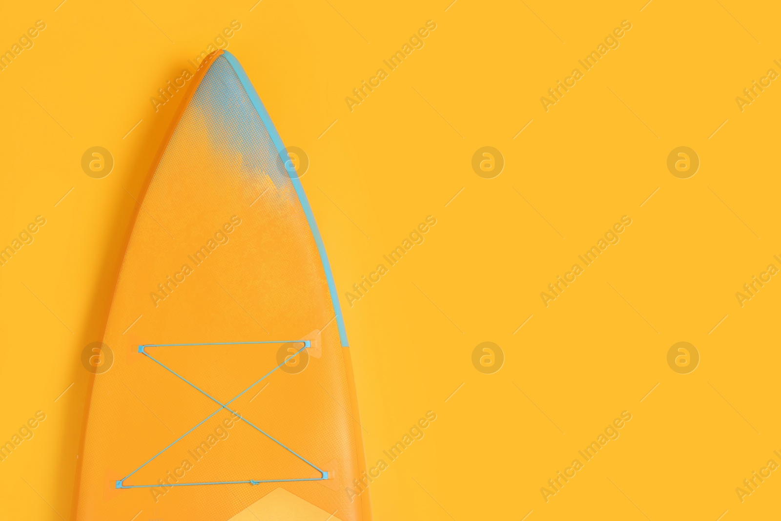 Photo of One SUP board on orange background, top view with space for text. Water sport