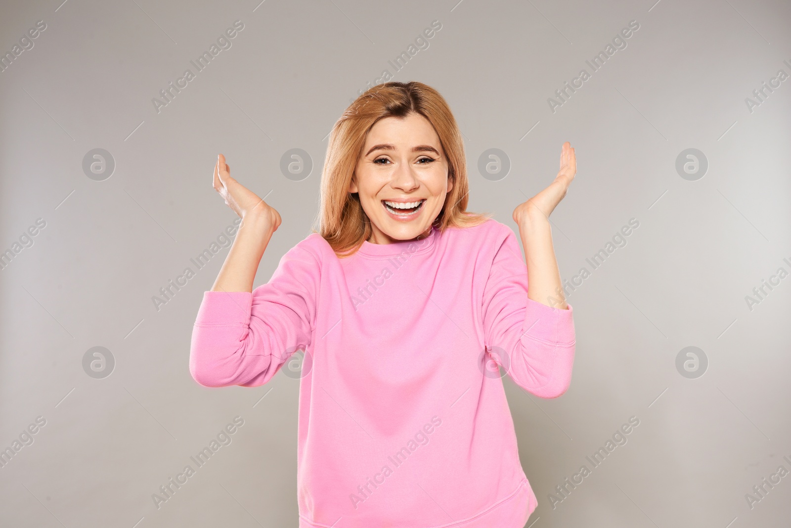 Photo of Portrait of emotional woman posing on grey background