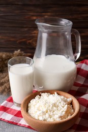 Tasty fresh milk and cottage cheese on grey table