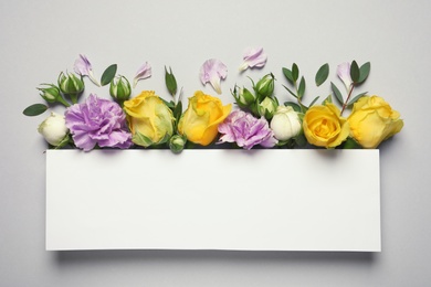 Photo of Flat lay composition with beautiful blooming flowers on grey background