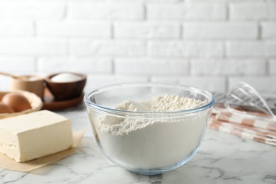 Making shortcrust pastry. Flour in bowl and butter on white marble table