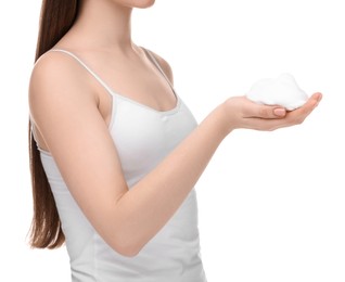 Woman with cleansing foam on hands against white background, closeup