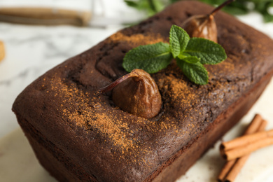 Photo of Tasty pear bread with mint on table, closeup. Homemade cake