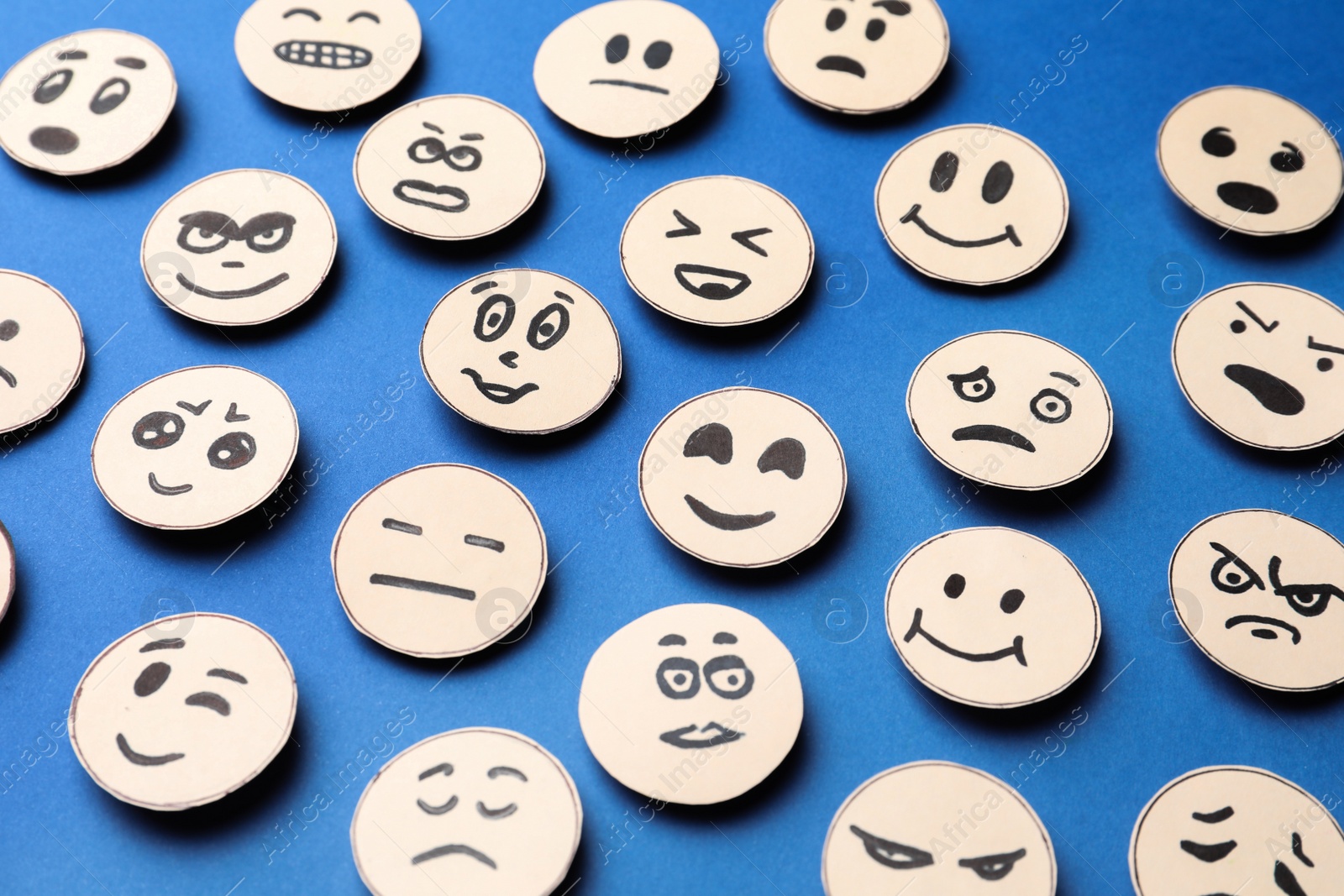 Photo of Many faces with different emotions on blue background