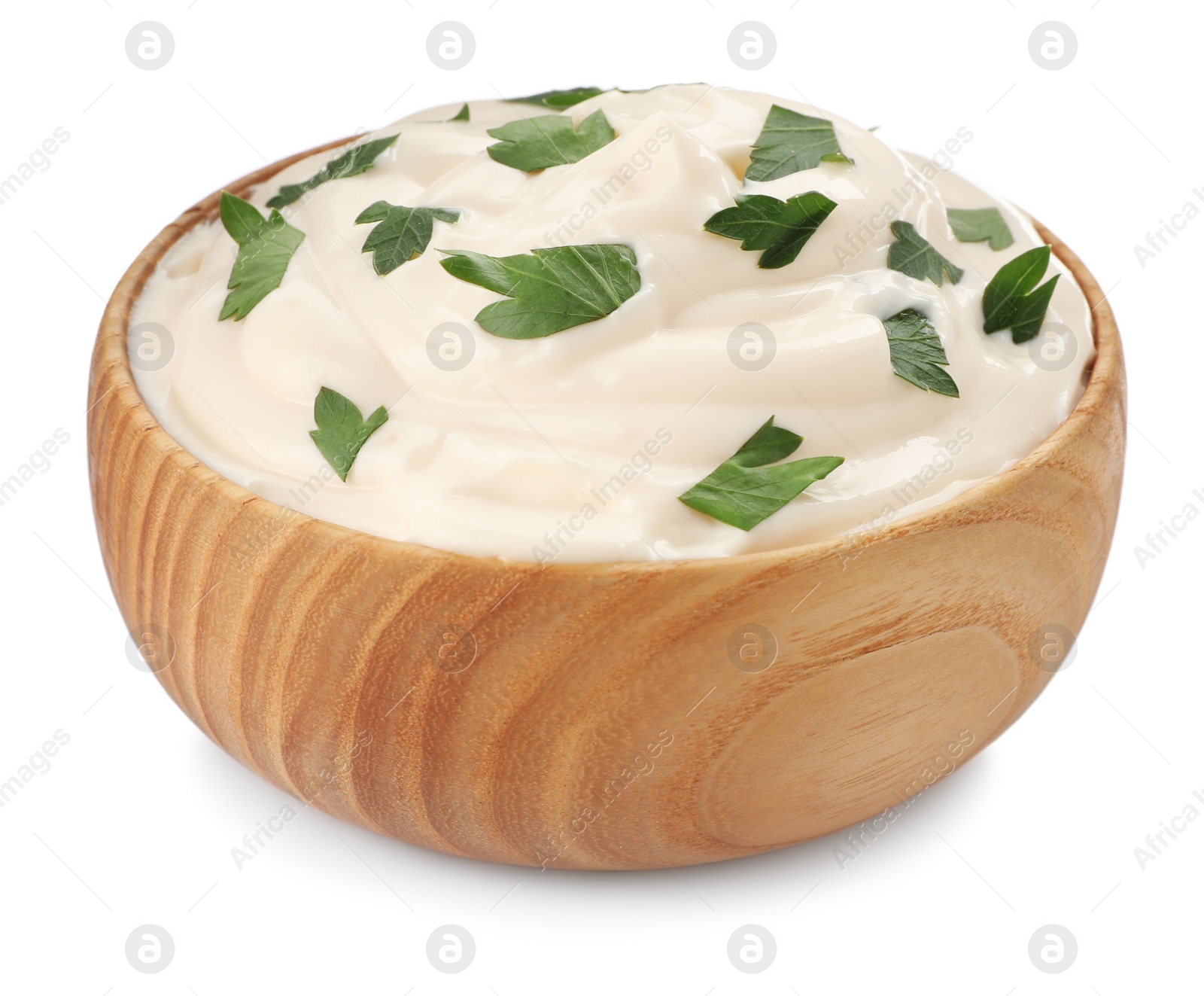 Photo of Mayonnaise with parsley in wooden bowl isolated on white